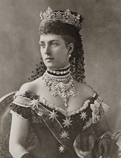 an old photo of a woman wearing a tiara