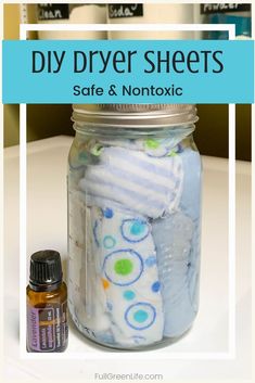 a mason jar filled with baby diapers next to an essential oil bottle that says diy dryer sheets safe and nontoxic