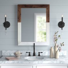 a bathroom vanity with two sinks and a large mirror above the sink is decorated with flowers