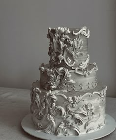 a three tiered wedding cake sitting on top of a white plate