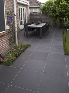 an outdoor patio with table and chairs