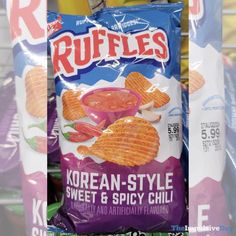 korean style sweet and spicy chili chips are on display in a grocery store for sale