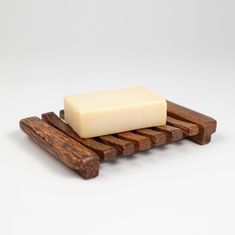 a bar of soap sitting on top of a wooden rack