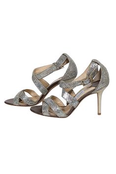 Sparkle and shine in these metallic Jimmy Choo strappy sandal heels! Featuring a glitzy design, they're the perfect match for any beaded cocktail dress or jazz up your skinny jeans with a touch of sparkle and a dazzling handbag! Size 6 (IT 36) Made in Italy Glitter-covered leather upper Strappy design with buckle closure Leather footbed Leather sole Heel 3.5" Jimmy Choo Silver Heels, Evening Heels With Silver-tone Hardware, Jimmy Choo Metallic Heels, Luxury Silver-studded Evening Heels, Silver Strappy Sandals With 4-inch Heel, Beaded Cocktail Dress, Sandal Heels, Strappy Sandals Heels, Snakeskin Print