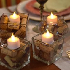 wine corks and candles are placed in small glass containers on a dining room table