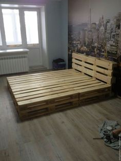 a bed made out of wooden pallets in a room