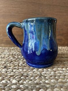 a blue mug sitting on top of a rug