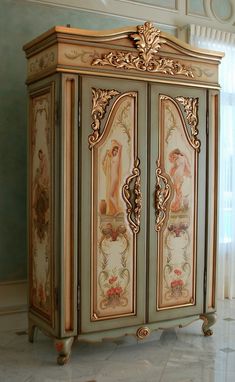 an ornately painted armoire in the corner of a room with white tile flooring