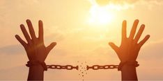 two hands are chained to each other with the sun in the background