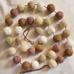 a bunch of wool balls on a string