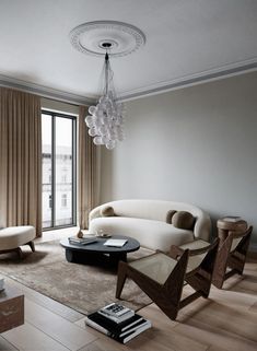 a living room filled with furniture and a chandelier