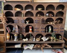 an old wooden shelf with many items on it