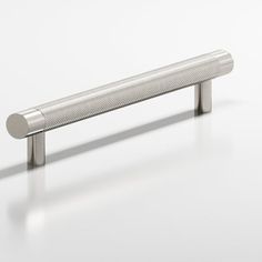 a metal handle on a white surface