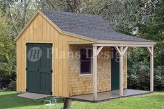 a small wooden shed sitting on top of a lush green field