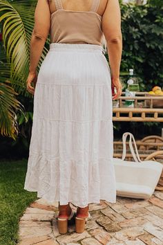 - Pair this flowy skirt with your favorite top for a trendy look! - Partially lined lightweight material with a subtle texture - A stretchy elastic waistband and with a faux drawstring accent - A relaxed silhouette that ends in a straight ankle length hemline White Relaxed Maxi Skirt For Vacation, White Flared Maxi Skirt For Beach, White Flared Maxi Skirt For Vacation, White Flared Maxi Skirt For The Beach, White Flowy Skirt For Vacation, White Tiered Skirt With Drawstring, White Maxi Skirt With Elastic Waistband For Day Out, White Flowy Ruffled Skirt Bottoms, Flowy Solid Color Beach Skirt