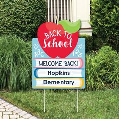 a welcome back to school sign in front of some bushes