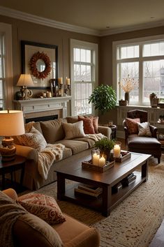 a living room filled with lots of furniture next to two large windows and a fire place