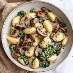 a white bowl filled with pasta and mushrooms