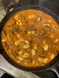 a pan filled with food sitting on top of a stove