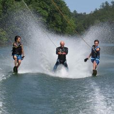 three people on water skis being pulled by a boat