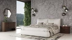 a bedroom with marble walls and flooring has a large white bed in the middle