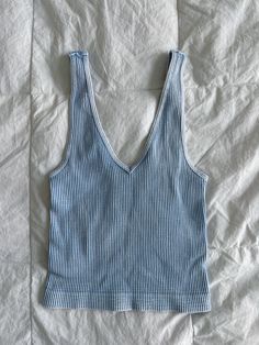 these tanks are made with super-elastic materials for maximum comfort & durability! they are one size fits most <3 they can be worn with the v neck in the front or the back depending on the look you’re going for! worn with the “do it” zip up! Everyday Cotton V-neck Tank Top, Basic Stretch V-neck Tank Top, Blue Ribbed V-neck Tank Top, Summer V-neck Ribbed Vest, Cotton V-neck Tank Top For Loungewear, Trendy Blue Vest Top, Summer Cotton V-neck Vest, Trendy V-neck Tank Top For Loungewear, Trendy Washed Blue Sleeveless Tank Top