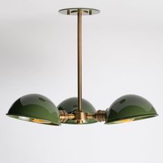 three green lamps hanging from a ceiling fixture