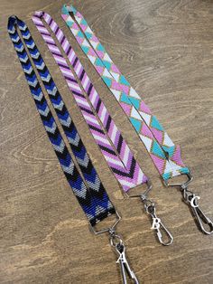 three lanyards on a wooden table with scissors