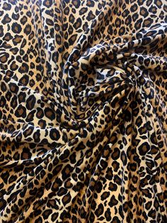 an animal print fabric with black and brown spots