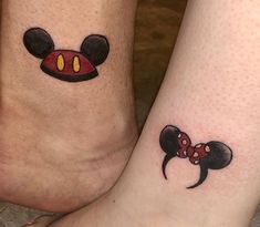 two people with matching mickey mouse tattoos on their feet, both have red and yellow eyes