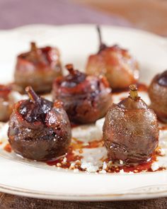 some meatballs are sitting on a white plate