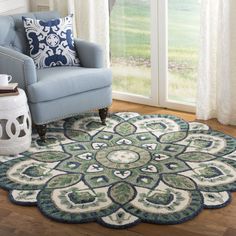 a living room with a blue chair and rug