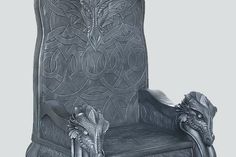 an intricately carved chair with a dragon on it's back and foot rest