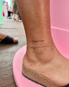 a woman's foot with a small tattoo on the ankle that reads, i love you