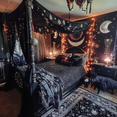 a bedroom decorated in black and white with lights on the ceiling, bedding and rugs