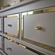 an image of a white dresser with gold handles