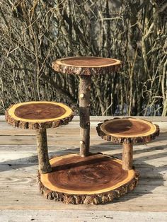 three tree stumps stacked on top of each other in the middle of a wood deck