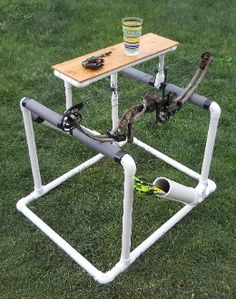 an upside down table with tools on it in the grass