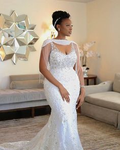 a woman in a white wedding dress posing for the camera