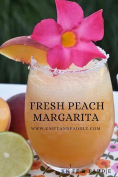 fresh peach margarita in a glass with pink flower on top