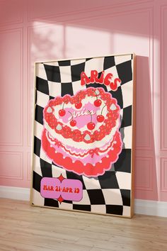 a pink and black checkered wall with a large cake on it's side