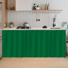 a kitchen with a green table cloth on the counter