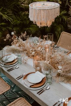 a table set with plates and place settings