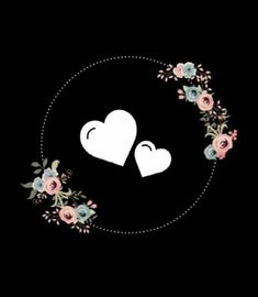 two white hearts surrounded by flowers on a black background