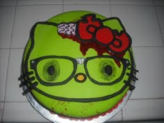 the cake is decorated with an image of hello kitty on it's face and glasses