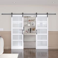 a living room with white furniture and sliding glass doors