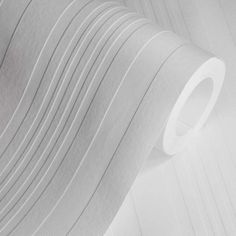 a white wallpaper with pleated lines on the side and a roll of toilet paper next to it