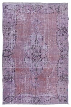 an old rug with faded pink and purple colors