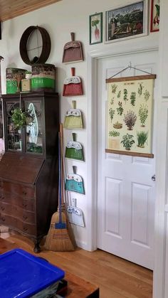 a living room filled with furniture and lots of pictures on the wall next to a door