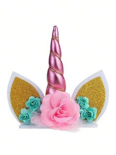 a pink and gold unicorn headpiece with flowers on it's side, against a white background